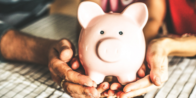 Couple holding piggy bank