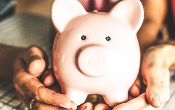 Person holding a piggy bank